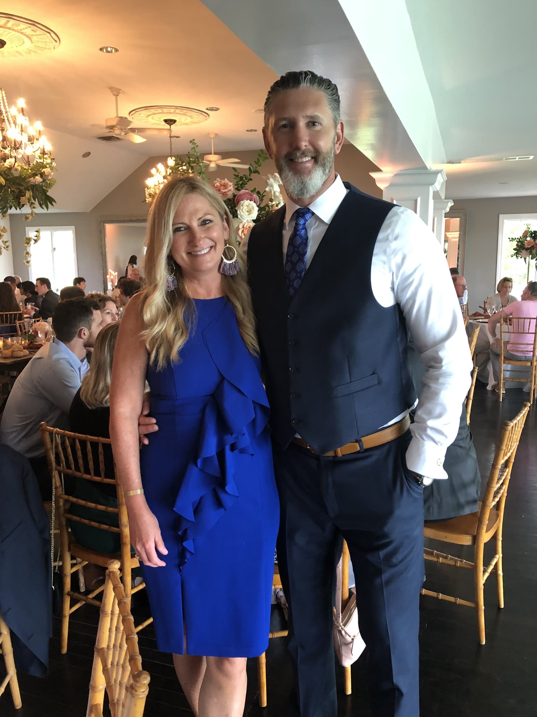 Rob Gunderson and his wife Lori standing together at a formal indoor event
