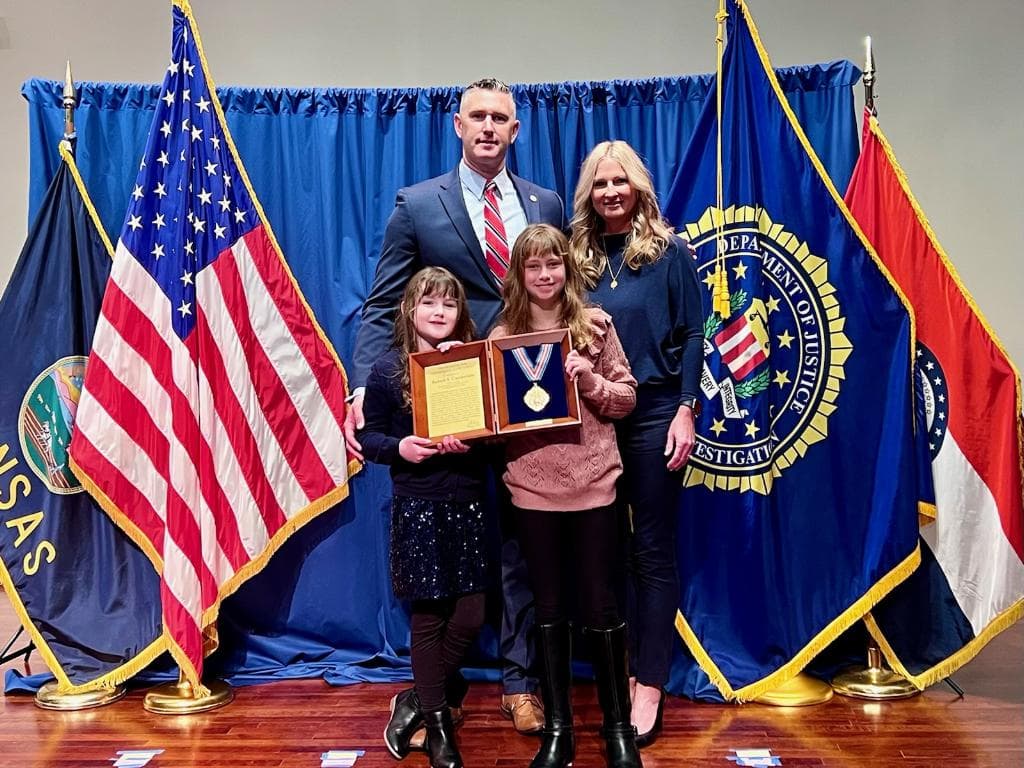 Rob Gunderson with his family at an award presentation