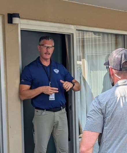 Rob Gunderson briefing a trainee in a doorway